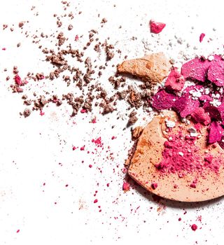 Crushed eyeshadow palette and powder close-up isolated on white background