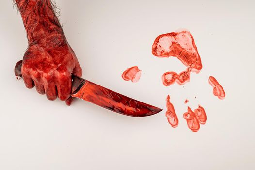 A man with bloody hands holds a knife on a white background.