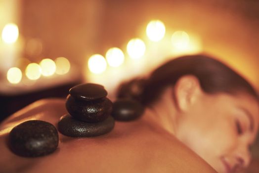 This massage rocks. a young woman enjoying a hot stone massage.