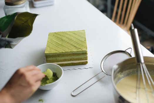 Pour green tea powder over delicious cheesecake