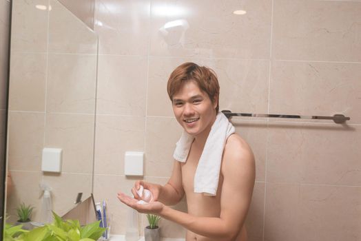 man is pouring cleansing milk on his hand
