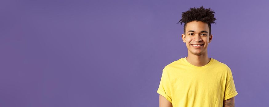 Close-up portrait of smiling, enthusiastic hispanic male student searching job, consider career opportunities, recruiting to company, smiling cheerful standing purple background