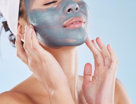 Skincare, facial and beauty with woman with face mask for cosmetics luxury, relax or acne against blue background studio. Salon, product and dermatology for wellness, spa and treatment