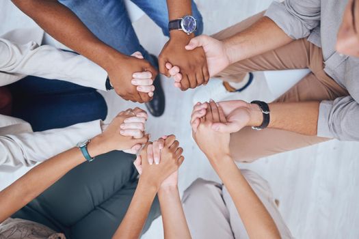 Support, prayer and trust with hands of people praying in spiritual faith and comfort in a meeting from above. Help, hope and worship with a group sitting in a circle of community and mental health