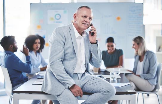 Leadership, phone call and communication while a ceo sit in a meeting with a team of corporate men and women. Workers in at presentation with senior manager while talking on phone in conference room
