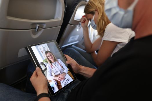 Airplane passengers communicate with doctor remotely via video call
