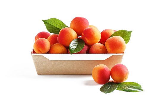 Apricots in paper packaging on a white background. the concept of eco-friendly packaging without plastic.