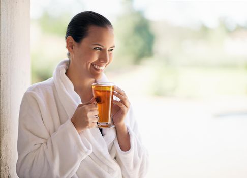 The spa is her sanctuary. a young woman drinking an iced tea at the day spa.
