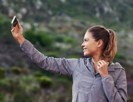 One more run selfie before the trail. a young woman taking a selfie while out for a trail run.