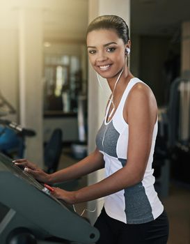 Time to burn some calories. a young woman exercising on a treadmill at the gym.