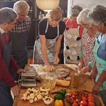 Nothing brings people together like good food. a group of seniors attending a cooking class.