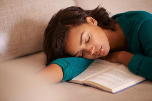 Inspiration for a beautiful dream. a young woman napping on the sofa with a book.