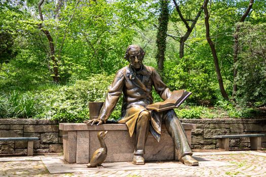 Sculpture of Hans Christian Andersen reading book to a duck in the Central Park in New York
