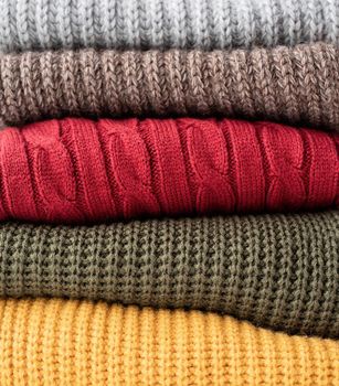 Stack of autumn warm sweaters