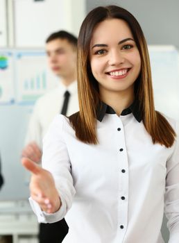 Smiling young business woman politely greets company office
