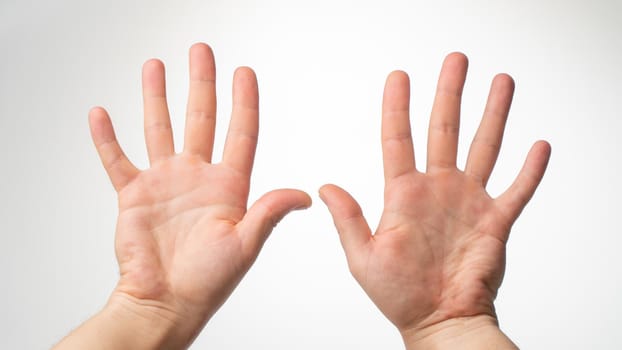 Men's hands gesture counting on fingers ten palmar side