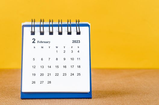 The February 2023 Monthly desk calendar for 2023 on yellow background.