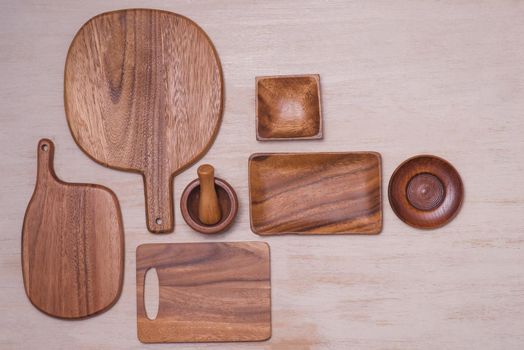 Set of kitchen utensils on vintage planked wood table from above, wooden background