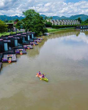 Couple men and women kayaking in the River Kwai Thailand
