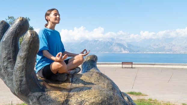 Meditation in nature against the backdrop of mountains and sea