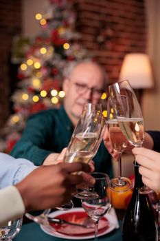 Diverse people hands clinking glasses with sparkling wine closeup
