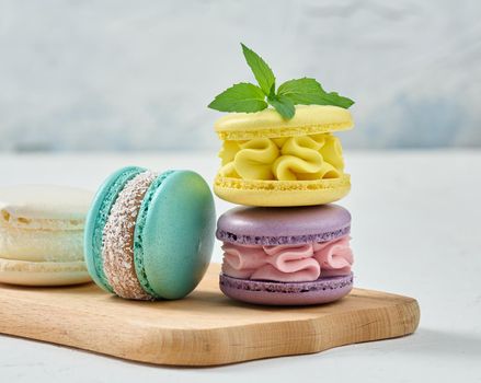Stack of colorful macaroons on white background