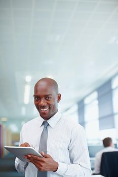 Business man using electronic PC. Handsome African American business man using tablet PC in an office.