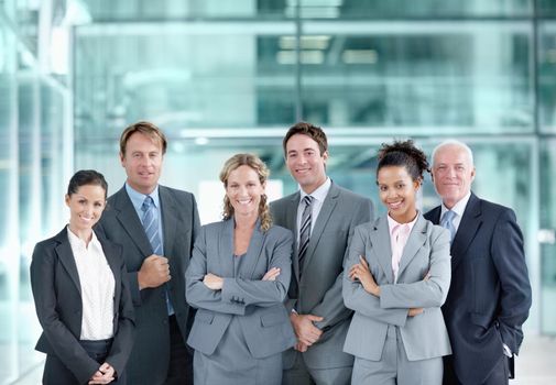 Filled with corporate confidence. Positive group of businesspeople standing together and smiling - portrait.