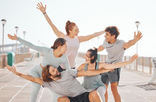 Friends, happy and excited hands outdoors while on exercise break together in gym clothes. Young social circle have goofy, silly and cheerful fun to celebrate their youth on the weekend.