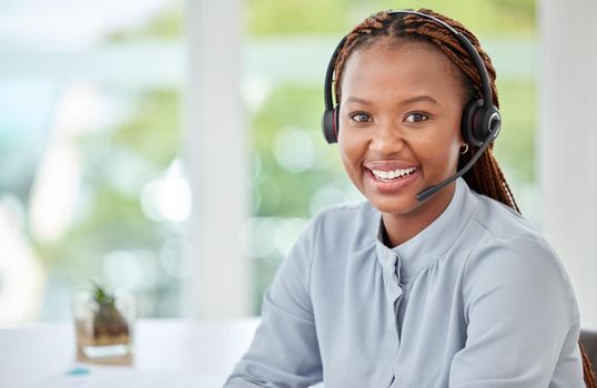 Portrait of a black customer support consultant, receptionist or call center agent with a headset. Happy, expert and professional woman employee working in ecommerce at a telemarketing company.