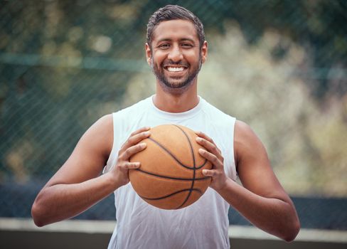 Basketball player, athlete and sports man with ball, skill and hobby for playing game, fun match or competition outdoors. Portrait of happy, fitness and indian man, goal motivation and ready to win