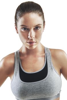 Focused on fitness. Cropped portrait of a young female athlete against white background.