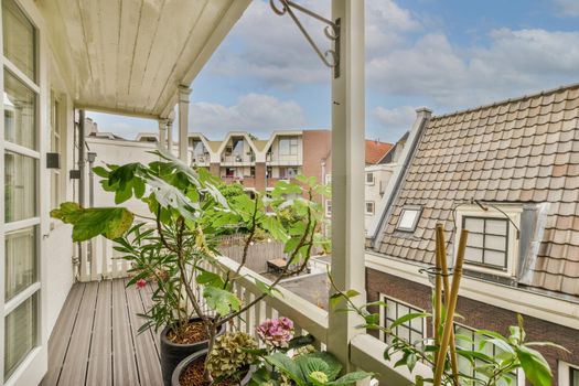 Narrow balcony with plants in the pot