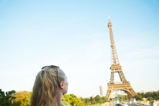 Its magnificent. Rear view of a young woman looking at the Eiffel Tower.
