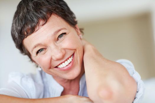 Mature business woman enjoying at home. Portrait of Caucasian business woman smiling while relaxing at home.