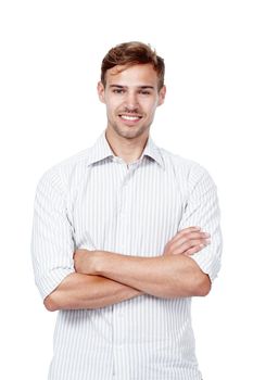 It is what it is. Studio portrait of a young man standing with his arms crossed against a white background.