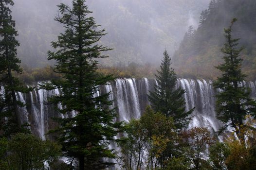Misty waterfalls in an ethereal landscape