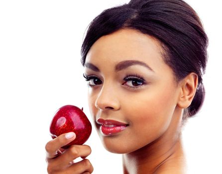 Beauty enhanced by healthy eating habits. A young woman in gymwear holding an apple and smiling at the camera.