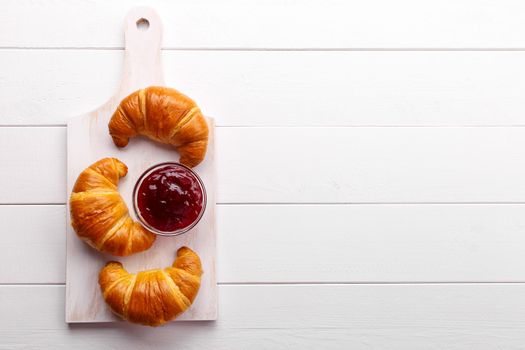 Traditional french croissant and strawberry jam