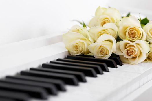 White piano and bouquet of roses