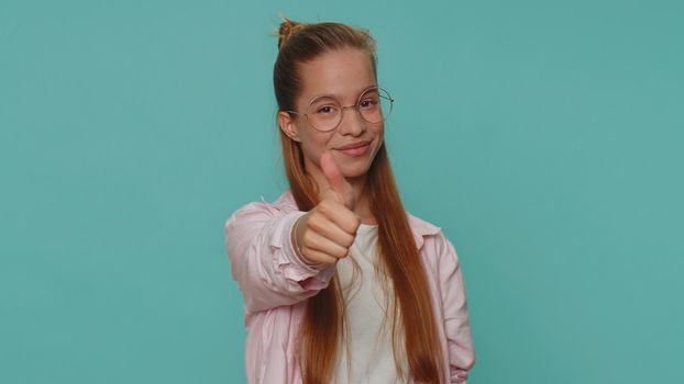 Pretty teen young girl showing thumbs up and nodding in approval, successful good amazing work job