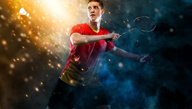 Badminton player. Man with racket and shuttlecock on golden background. Individual sports. Sports recreation.