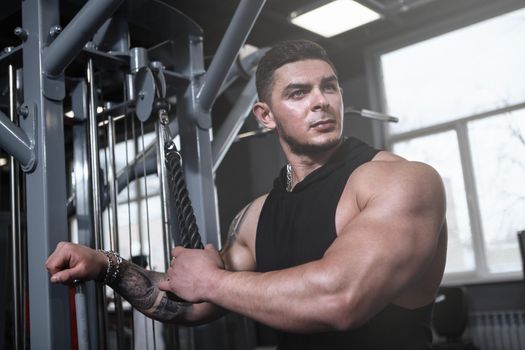 Muscular bodybuilder working out at gym