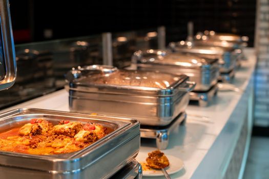Countertop food warmer with meat dish in hotel buffet restaurant