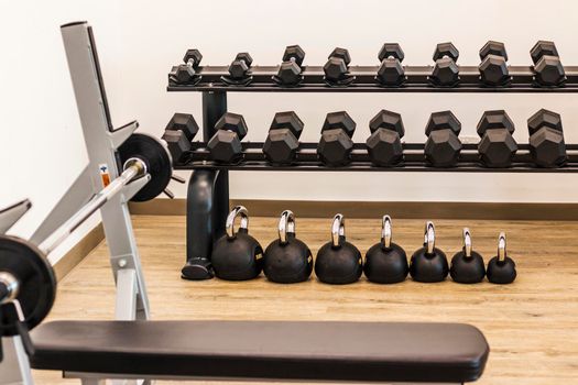 Close up shot of various gym equipment and weights. Fitness