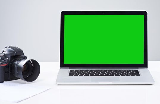 Your photography business deserves a great website. a laptop with a green screen.