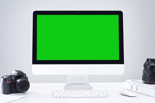 Advertise your photography business online. a desktop PC with a green screen.
