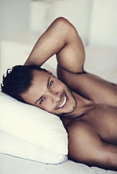Waking up with a smile on my face. a handsome young man in bed in the morning.