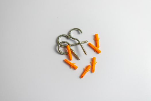 Heap of question mark hooks with plastic plugs on white background