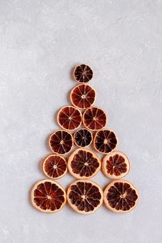 Christmas tree created of dry orange slices, minimalism